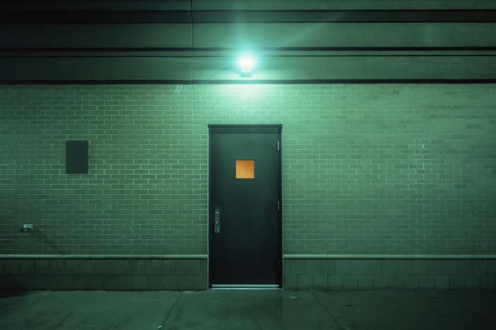 a door to a building with a light on