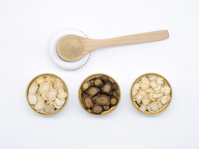 Close-up of traditional herbal medicine ingredients arranged on a wooden table.