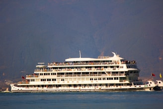 a large white boat floating on top of a body of water