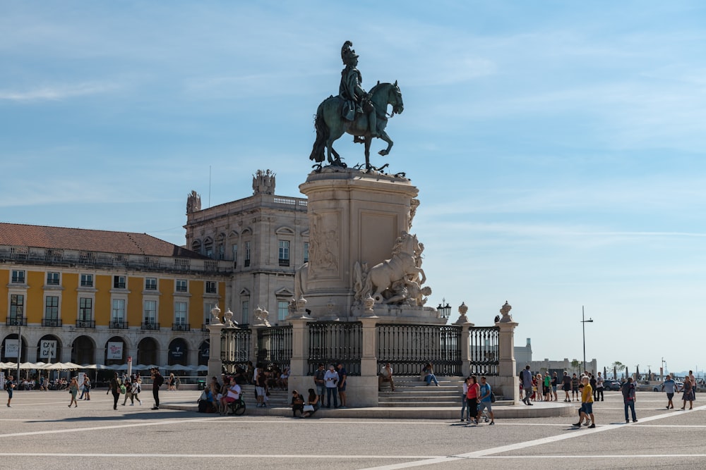 a statue of a man riding a horse in front of a building