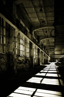 An abandoned industrial complex rendered with detailed textures and moody shadows creating a mysterious atmosphere.