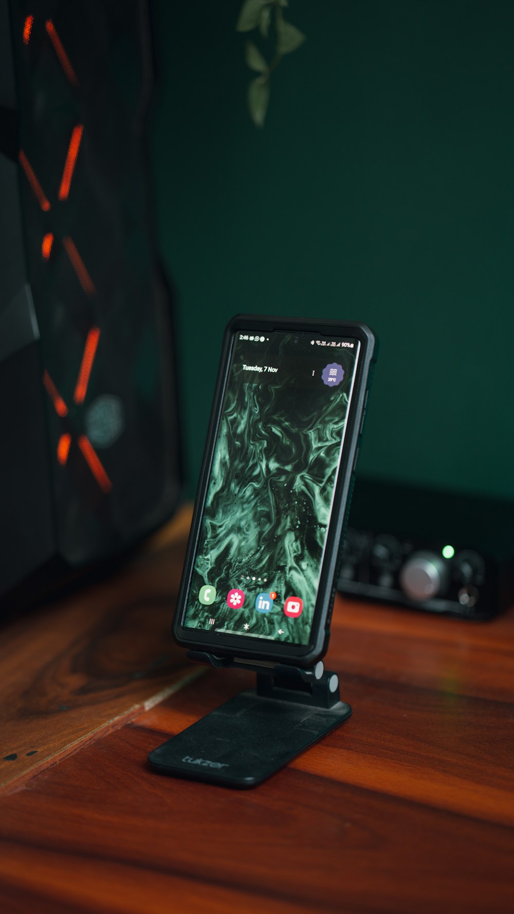 a cell phone sitting on top of a wooden table