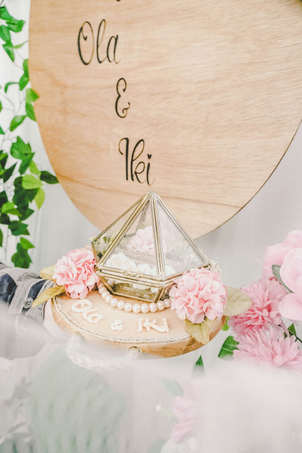 a wooden sign with a small pyramid on top of it