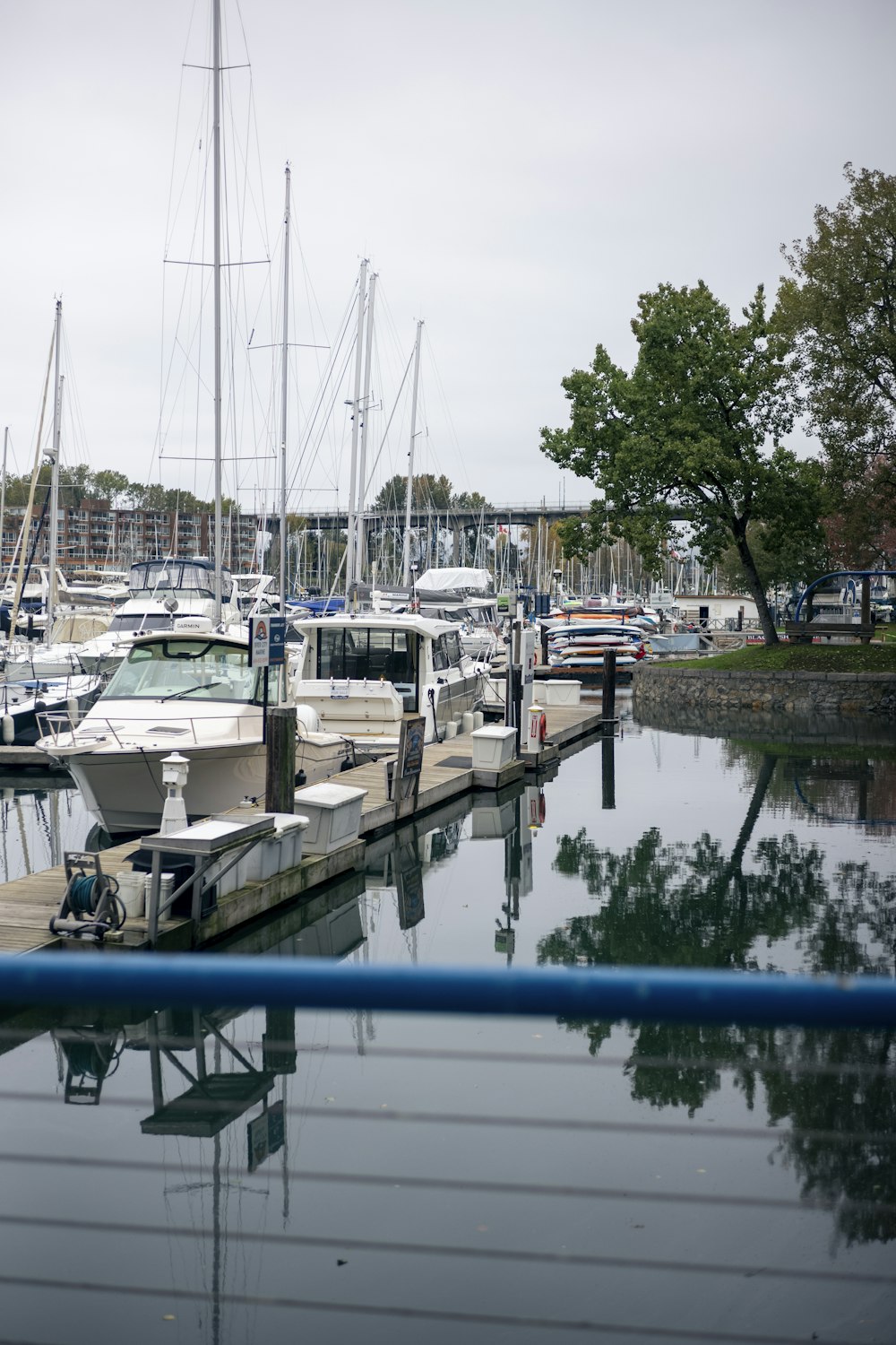 a marina filled with lots of boats on a cloudy day