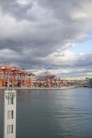 An aerial view of a bustling industrial area with cranes and shipping containers.
