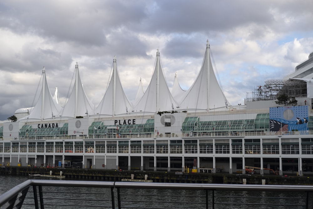 a large building with a lot of white umbrellas on top of it