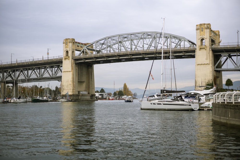 a bridge over a body of water with boats in it