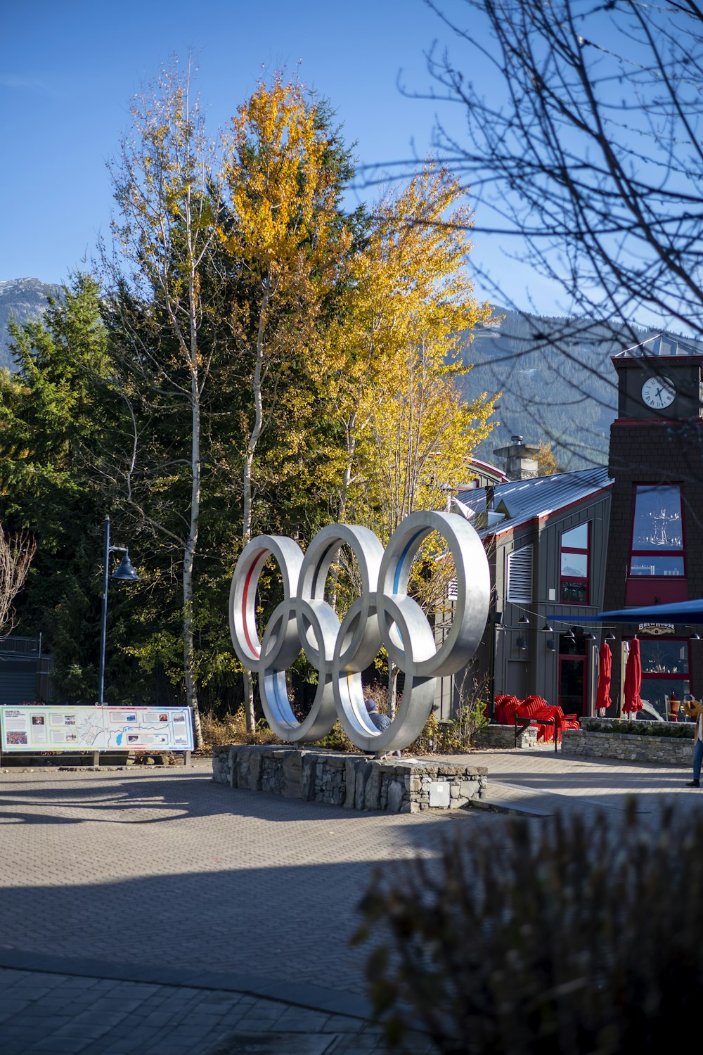 a sculpture of an olympic symbol in front of a building