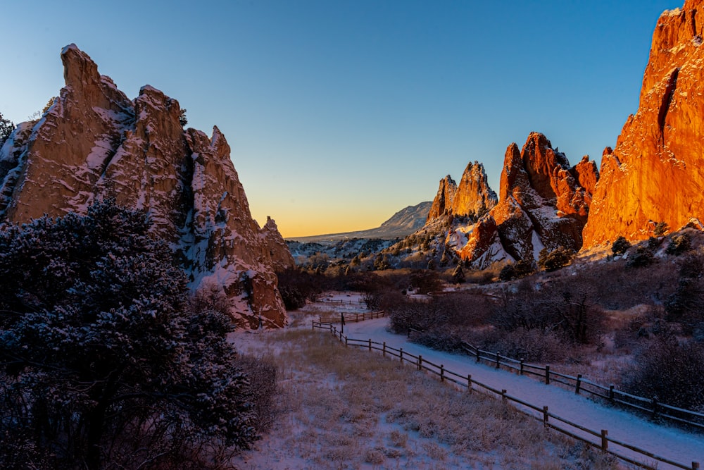 a snow covered field with mountains in the background