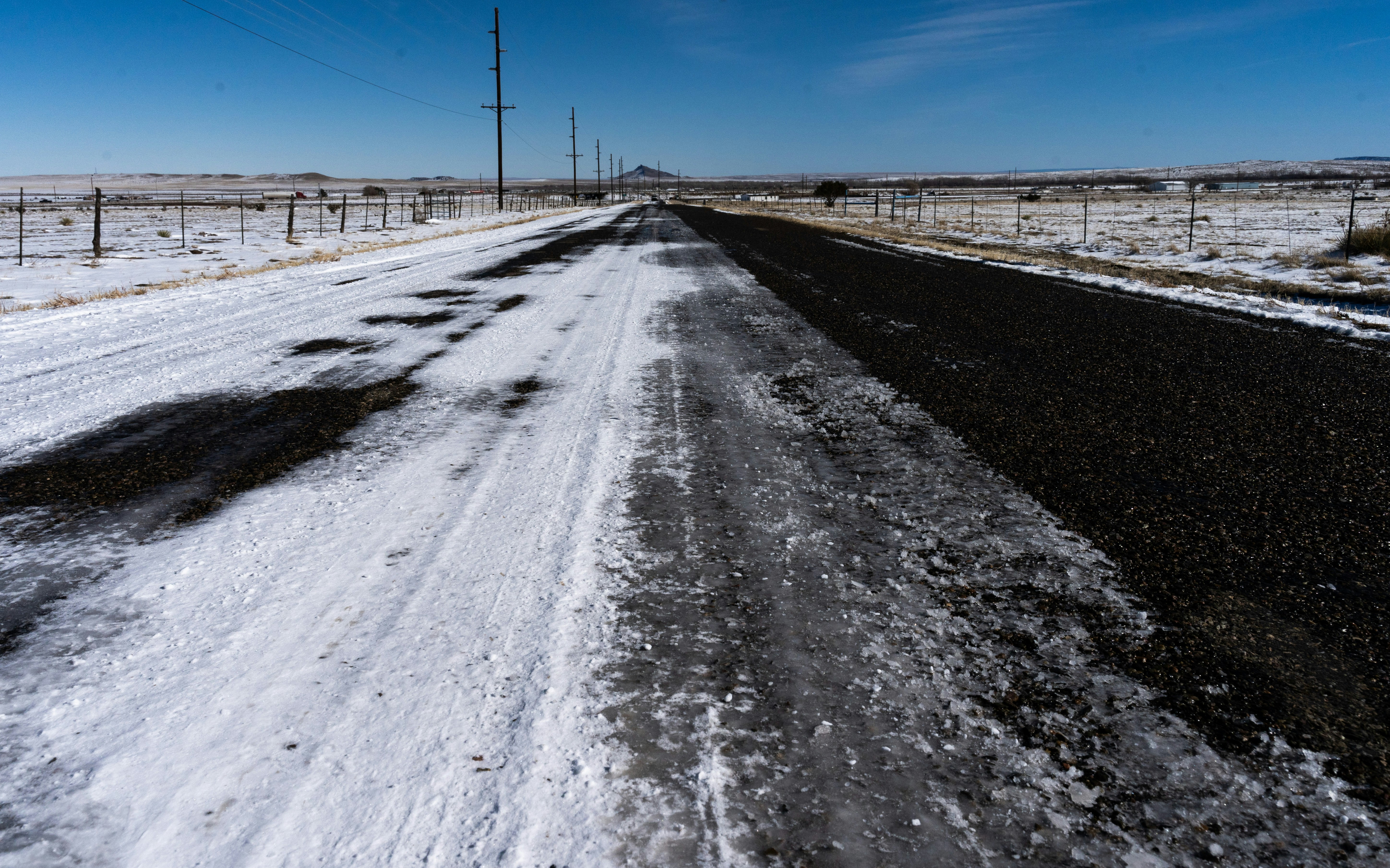 a snow covered road in the middle of nowhere