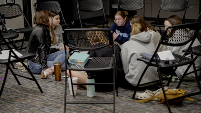 a group of girls sitting in a room next to each other