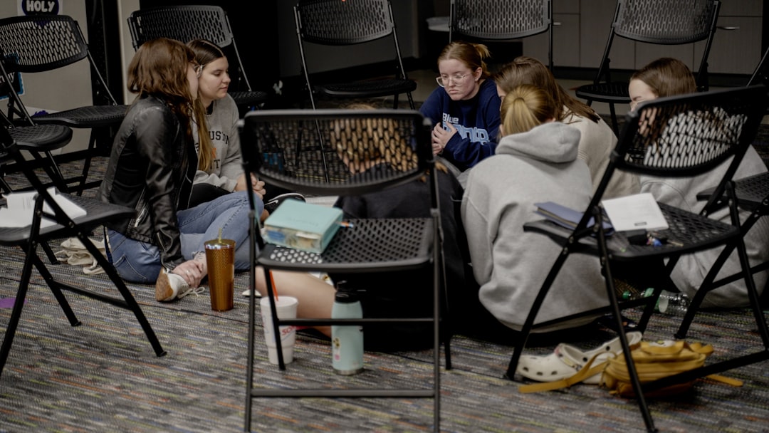 a group of girls sitting in a room next to each other