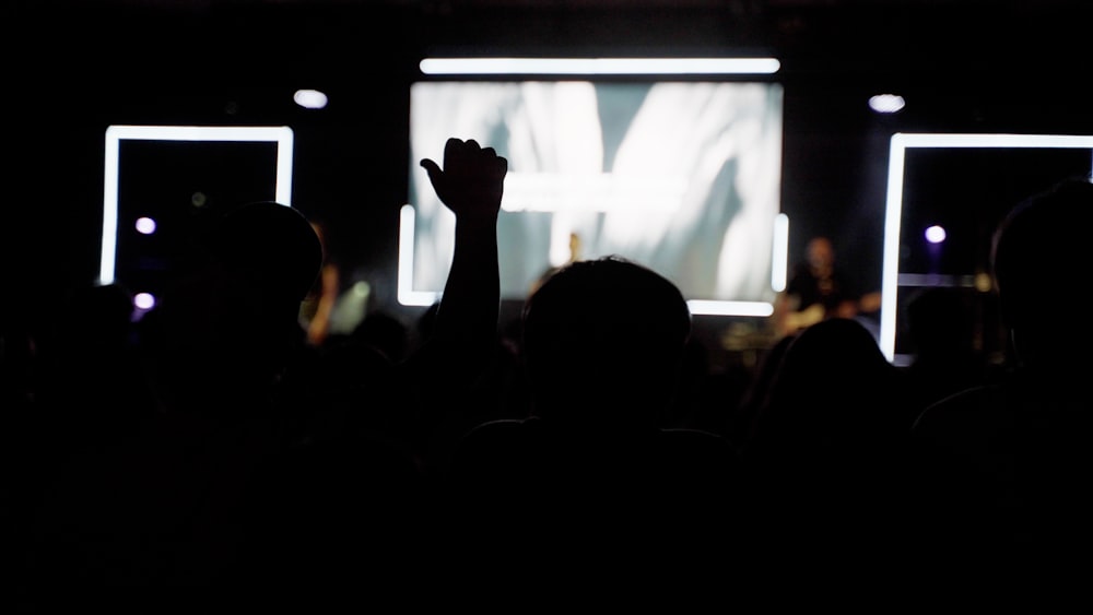 a group of people standing in front of a projection screen