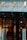 Glass storefront with sleek black doors, showcasing a luxurious and elegantly lit interior. The iconic brand name is prominently displayed above the entrance, set against a marble facade. Inside, there are upscale displays, plush furniture, and subtle lighting creating an opulent atmosphere.