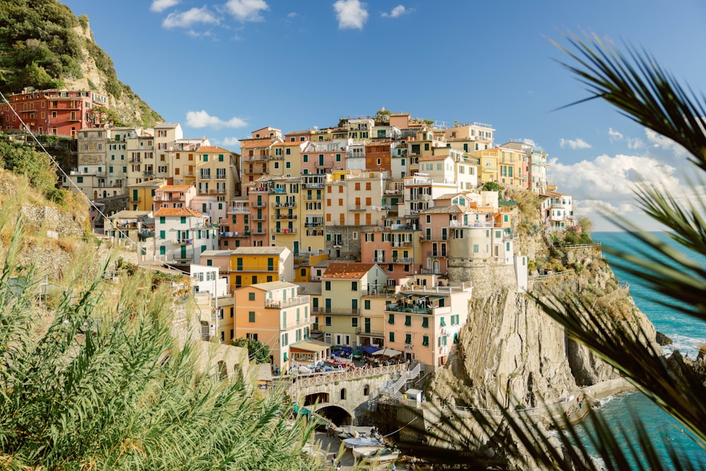 a view of a village on a cliff overlooking the ocean