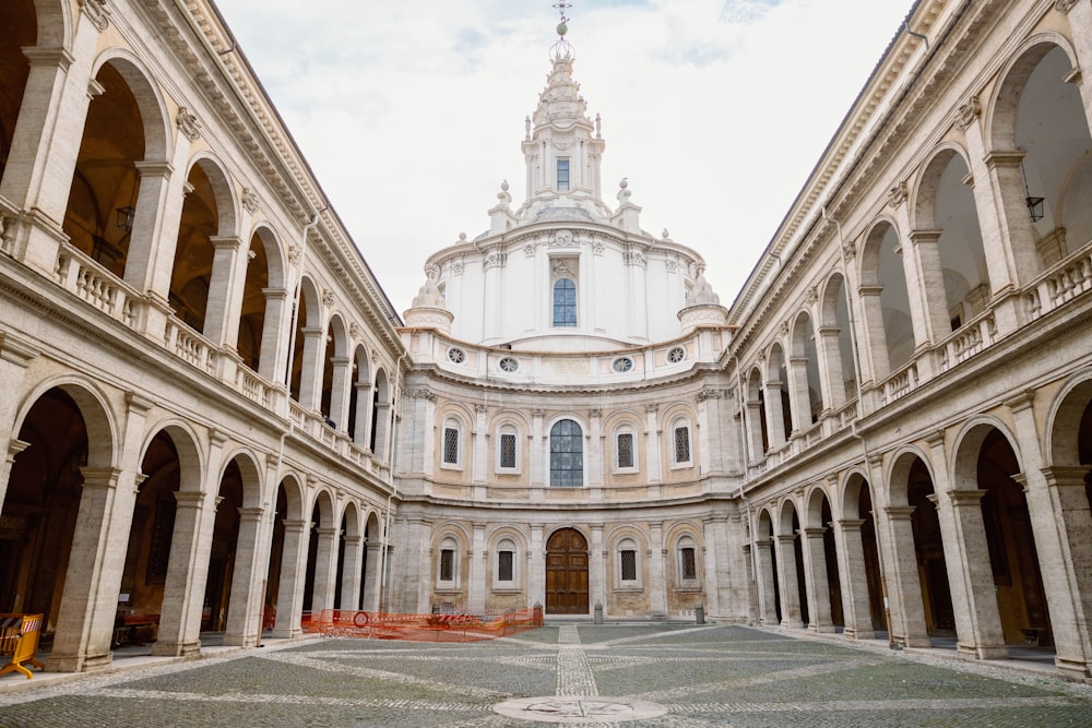 a large building with arches and a clock tower