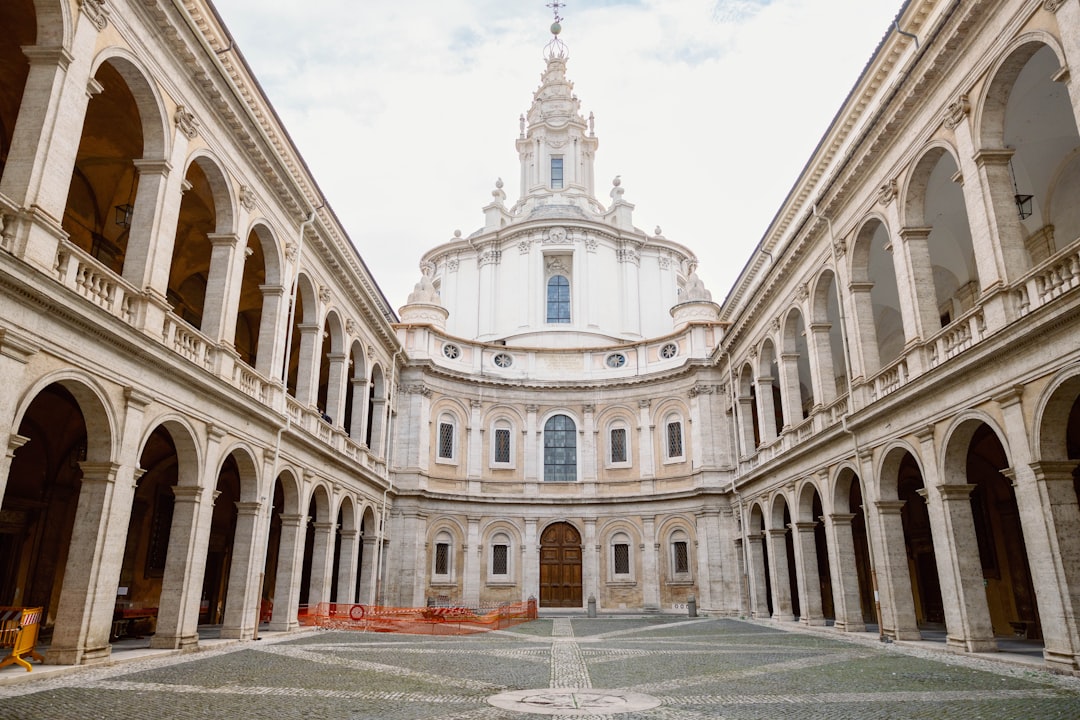 a large building with arches and a clock tower,