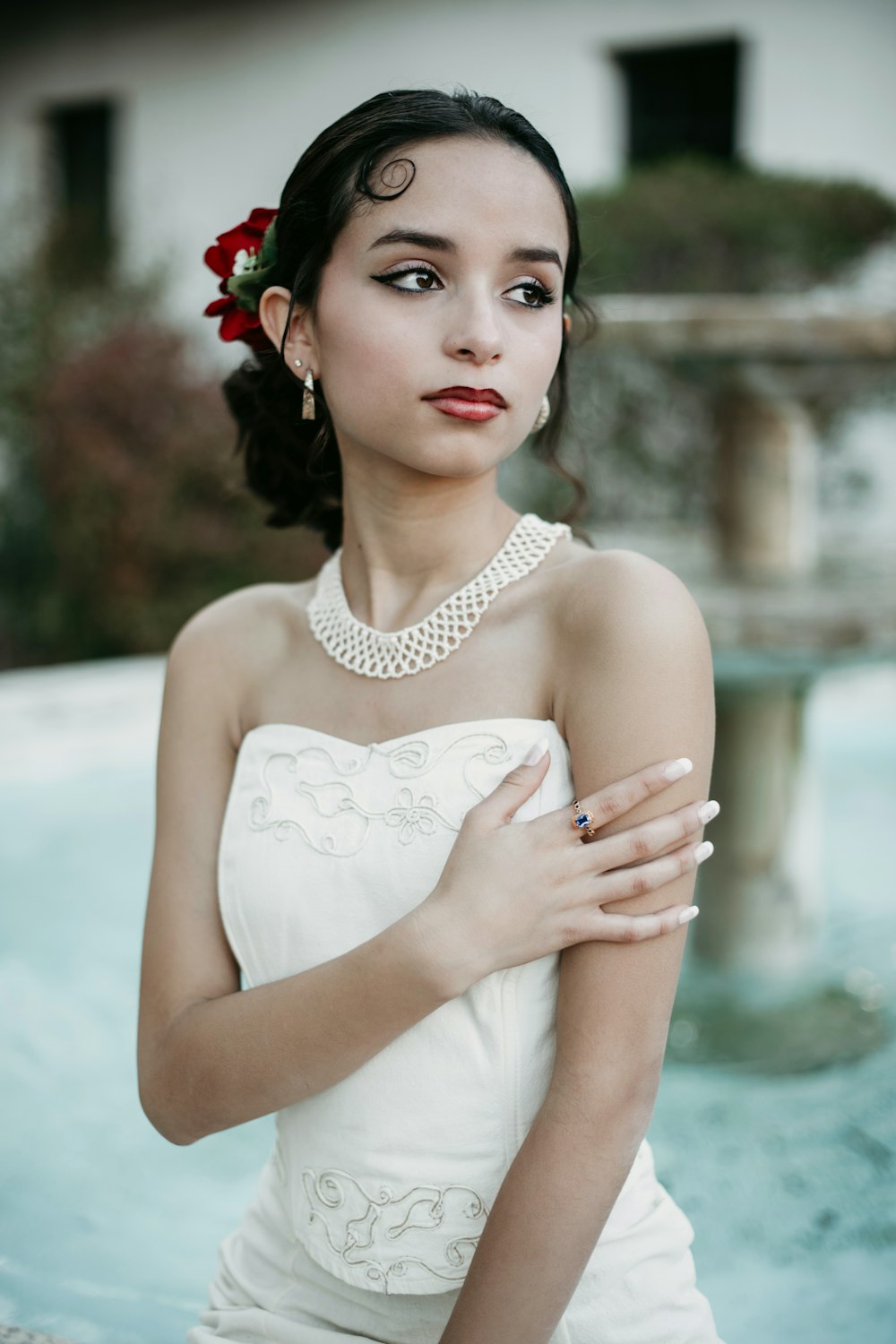 a woman in a white dress with a flower in her hair