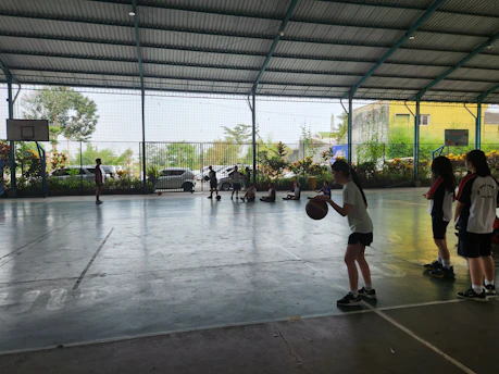A group of youth leaders engaged in a team-building activity indoors.