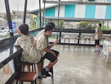 A casual group wearing printed shirts with visible QR codes in a social setting.