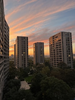 Sunset view of a completed apartment block with landscaped gardens.