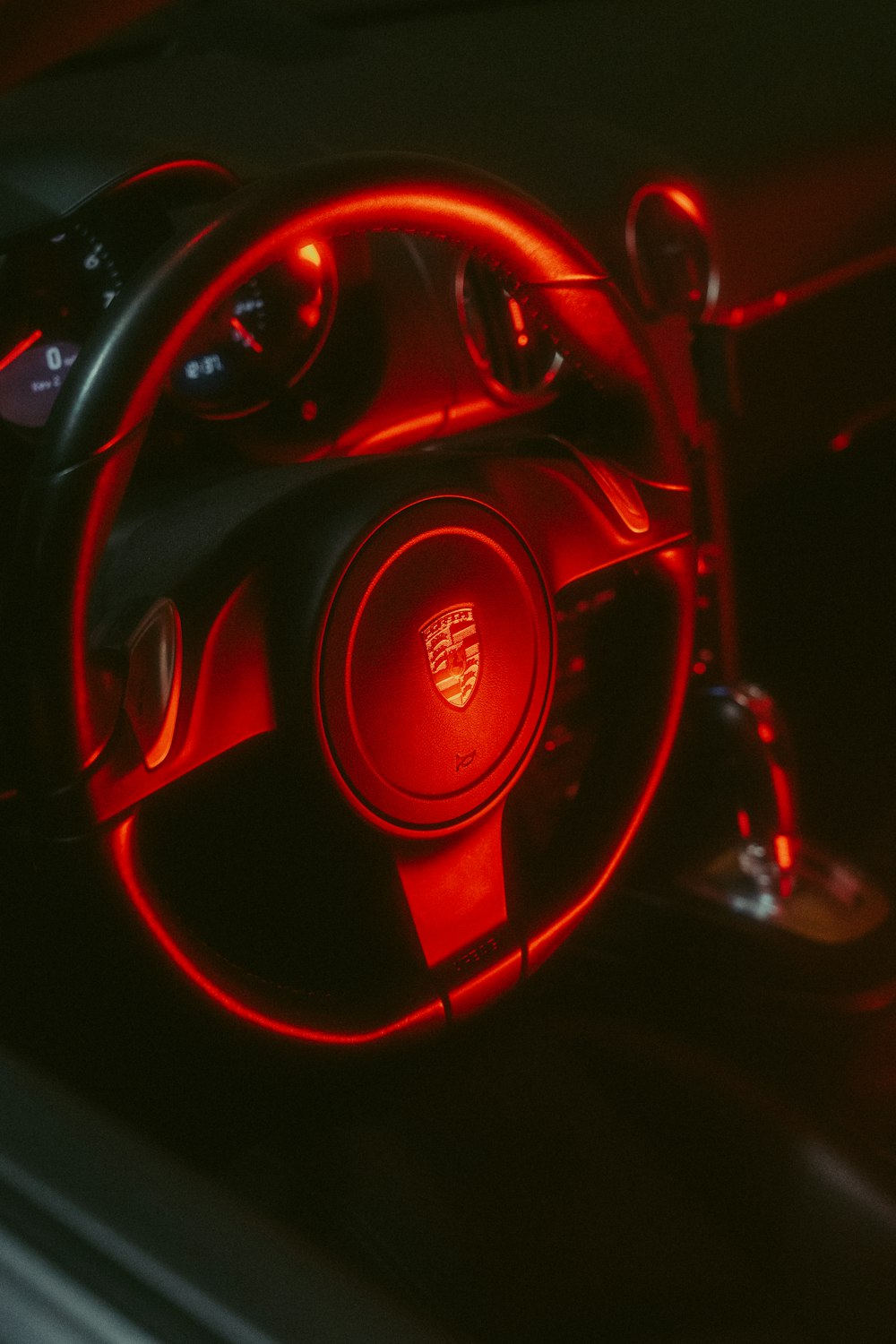a close up of a steering wheel with a red light