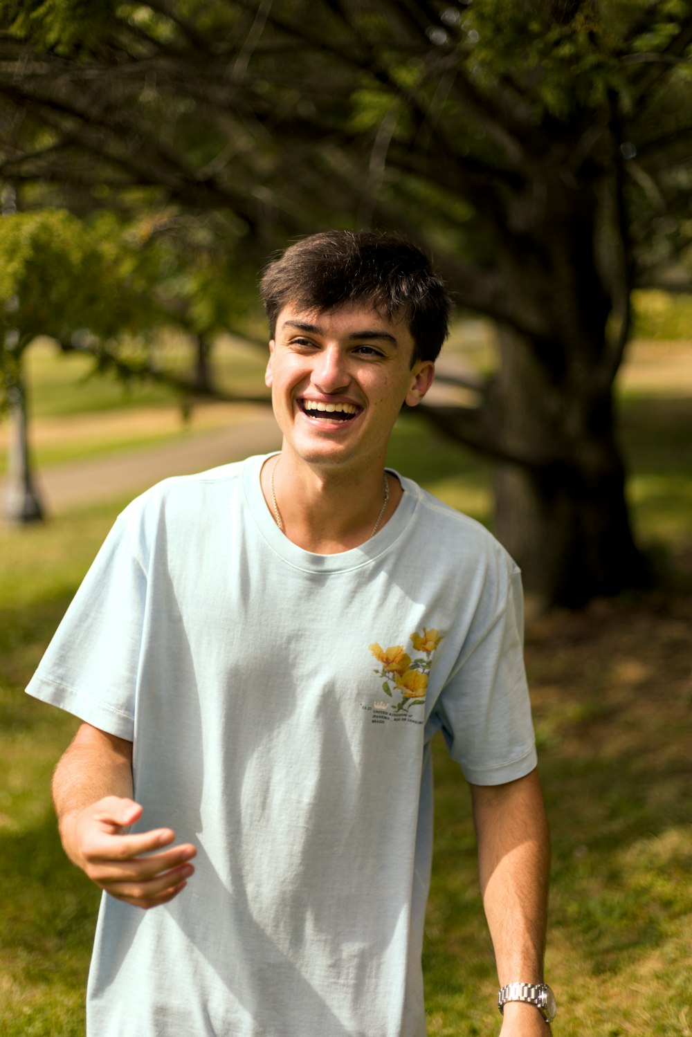 a young man smiles while holding a frisbee