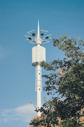 A sleek telecommunications tower standing tall against a clear blue sky.