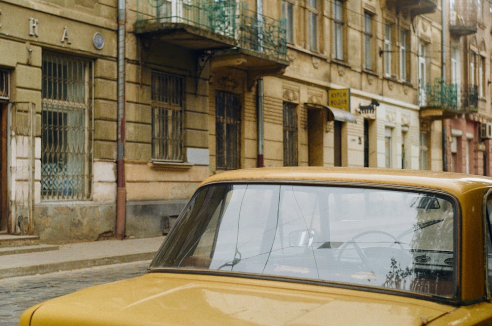 a yellow car parked on the side of a street