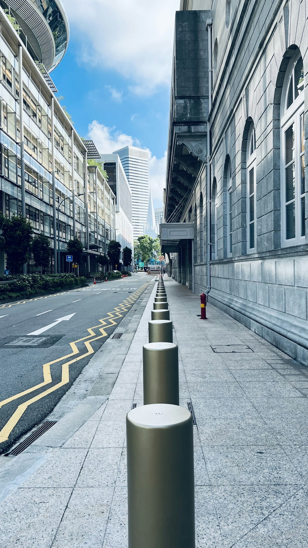 a street lined with tall buildings next to a street