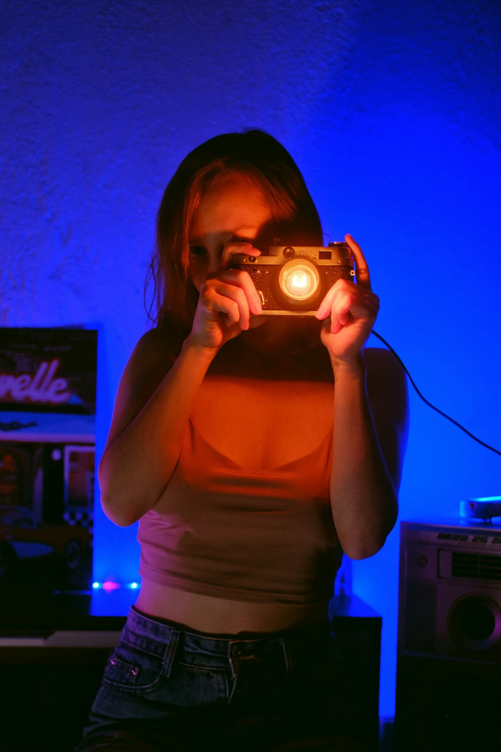 a woman holding a camera in front of her face