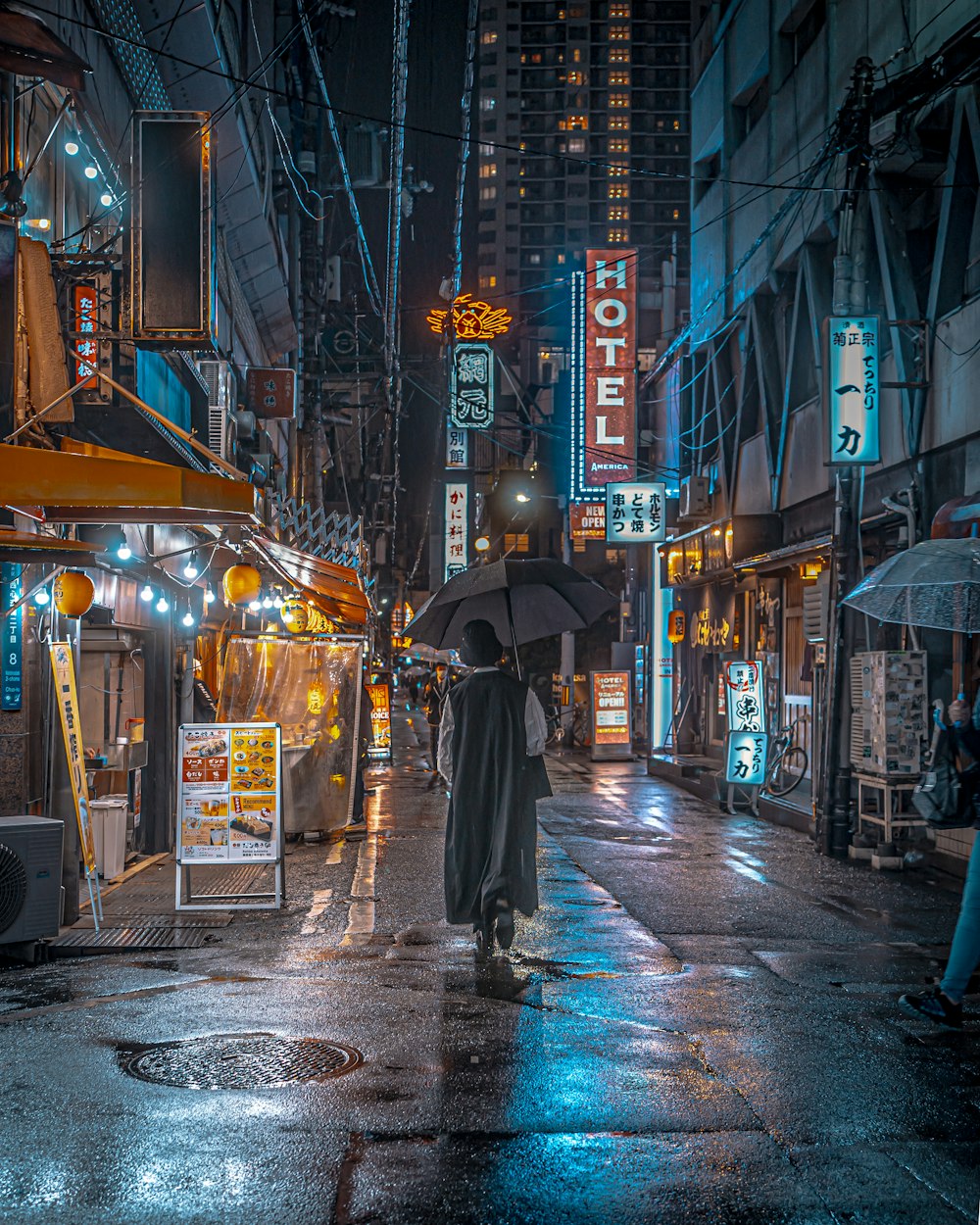 a person walking down a street holding an umbrella