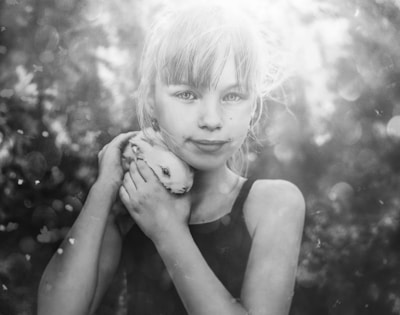 Children visiting an animal rescue center, gently petting a calm rescued rabbit.