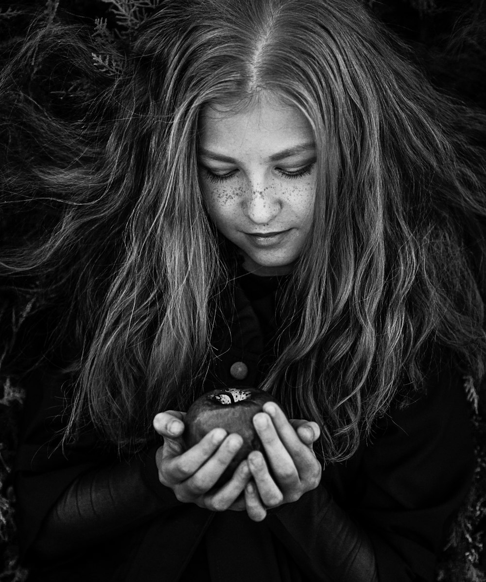 a woman holding an apple in her hands