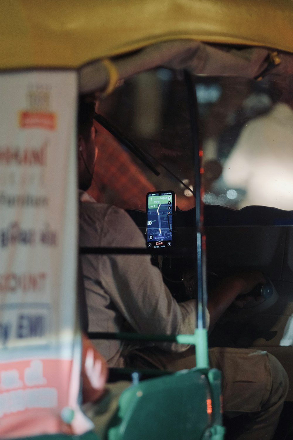a man sitting in a car holding a cell phone
