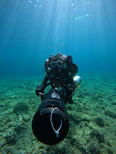Underwater thruster mounted on a small research submersible navigating coral reefs.