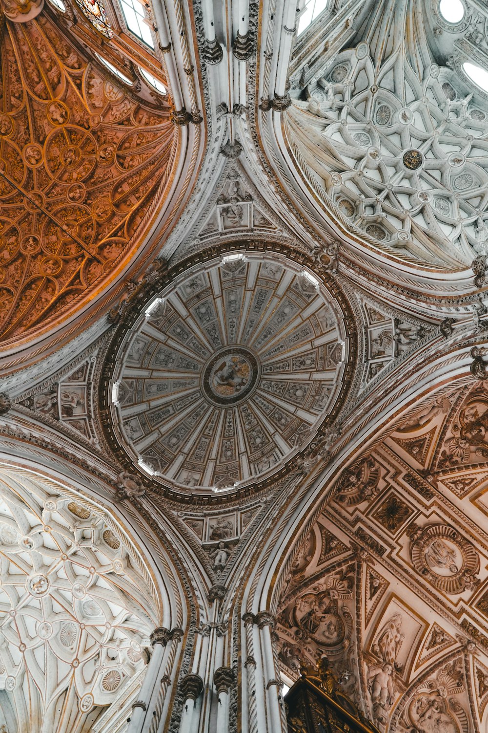 the ceiling of a cathedral with intricate designs