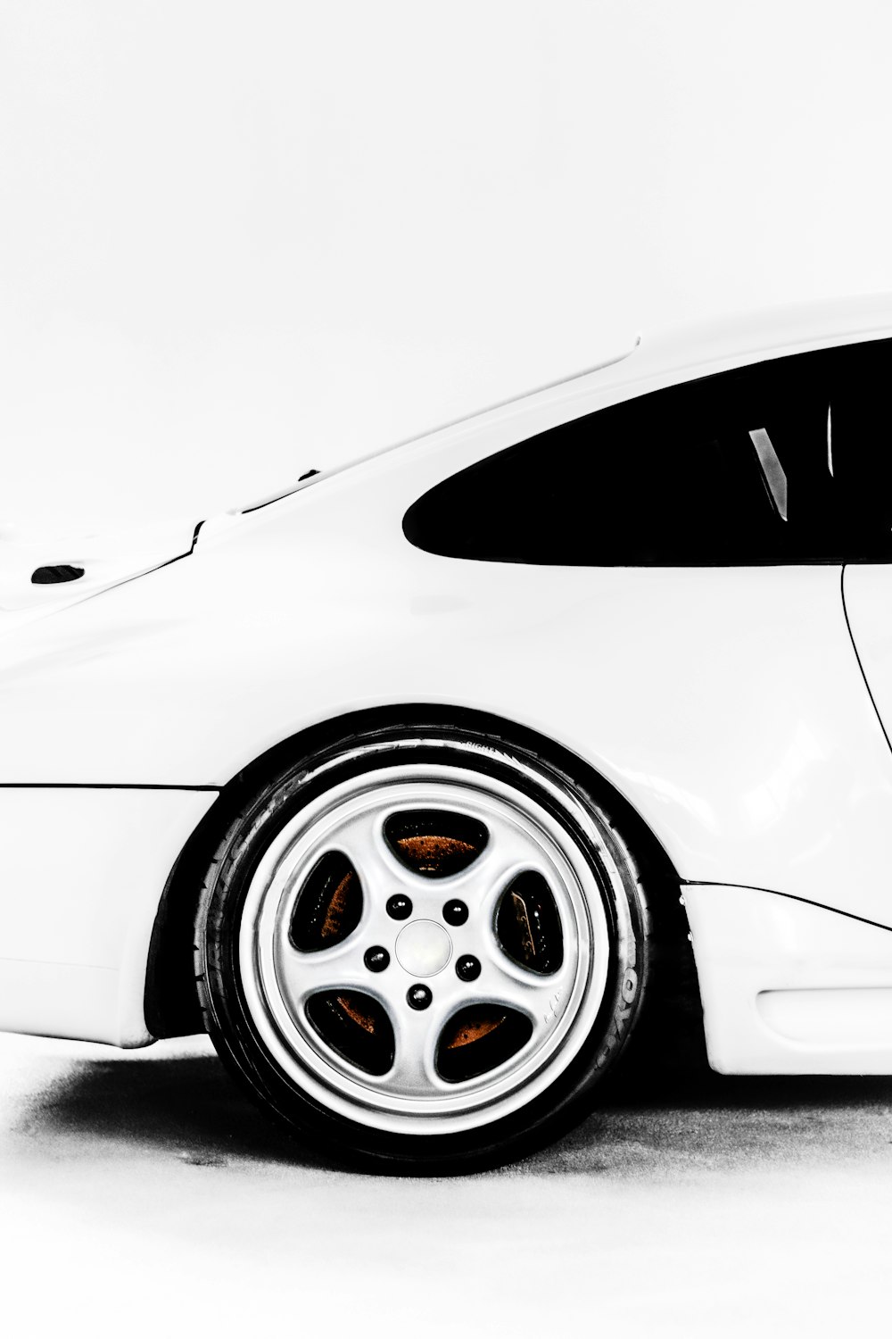 a black and white photo of a white sports car