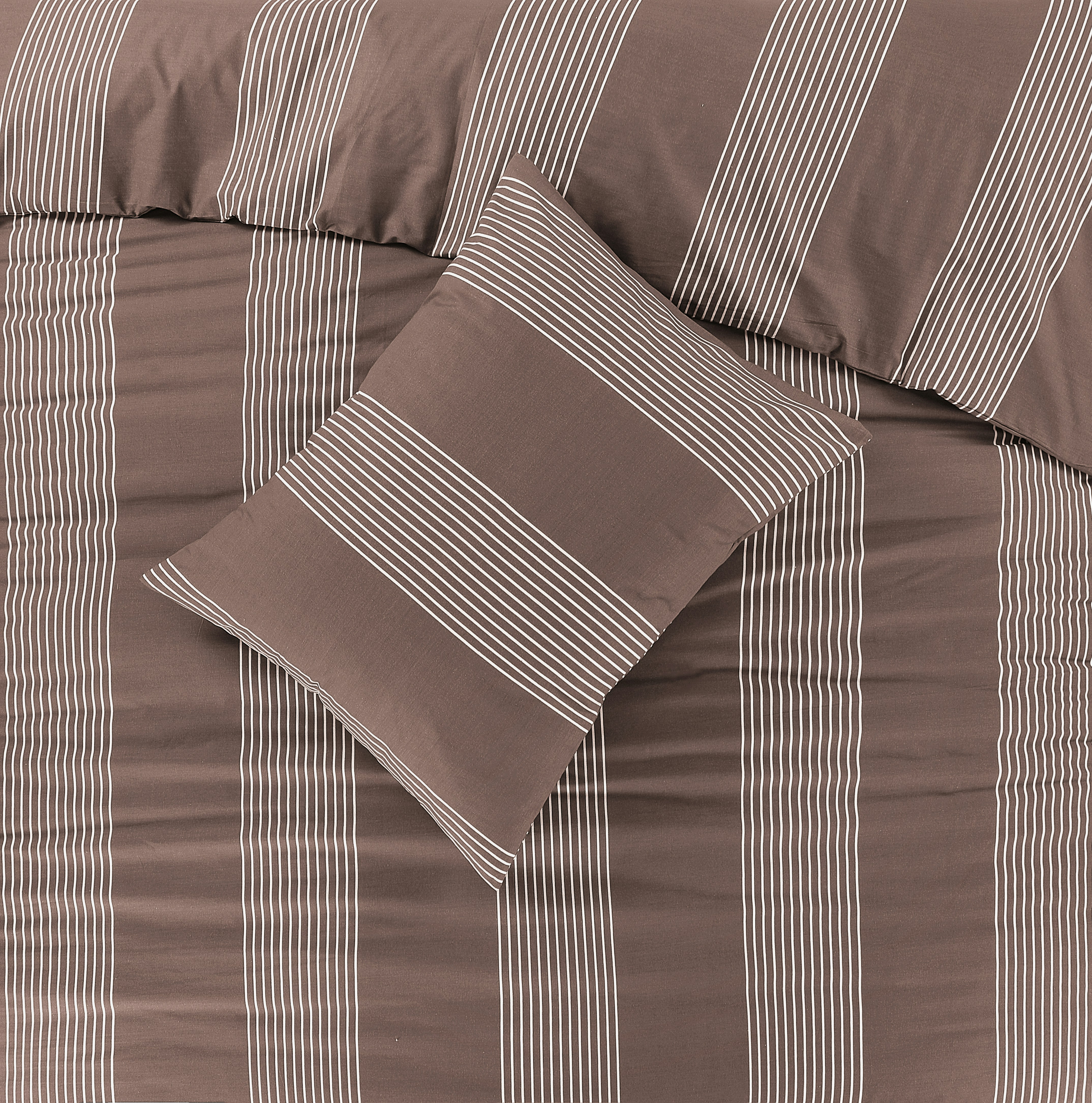 a bed with a brown and white striped comforter