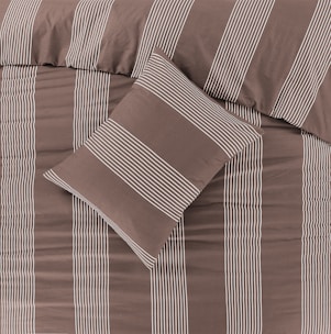 a bed with a brown and white striped comforter