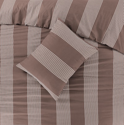 a bed with a brown and white striped comforter
