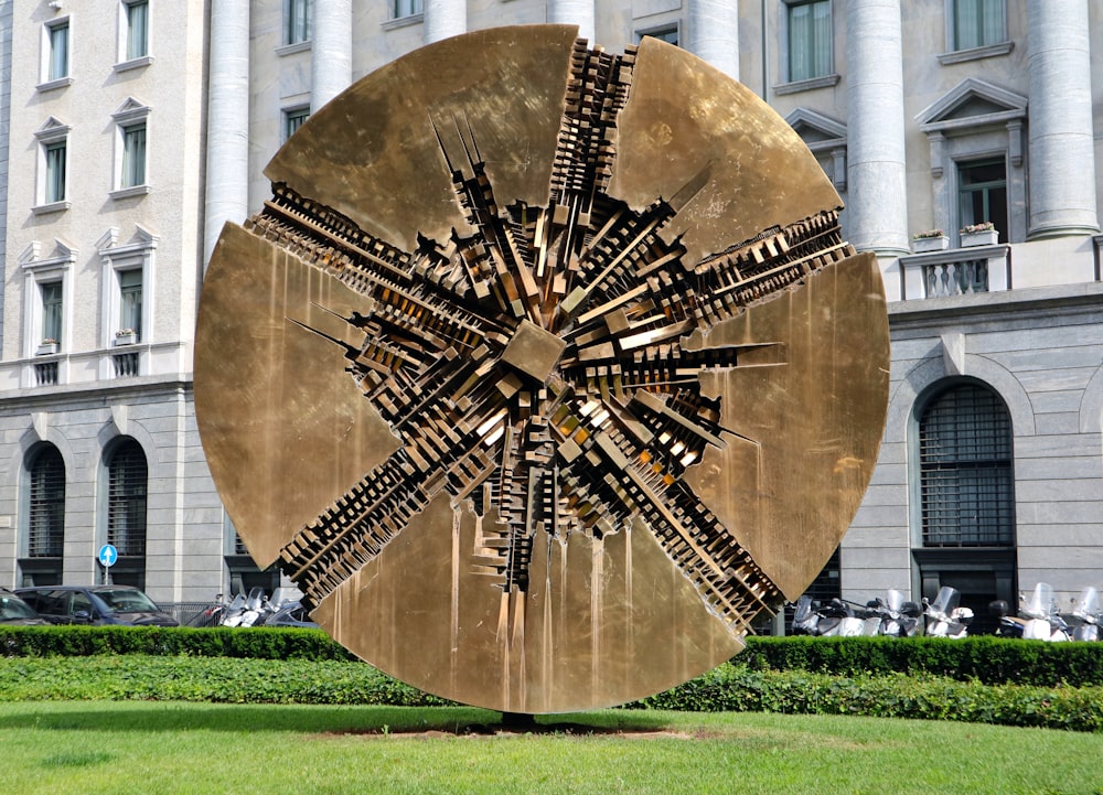 a large metal sculpture in front of a building