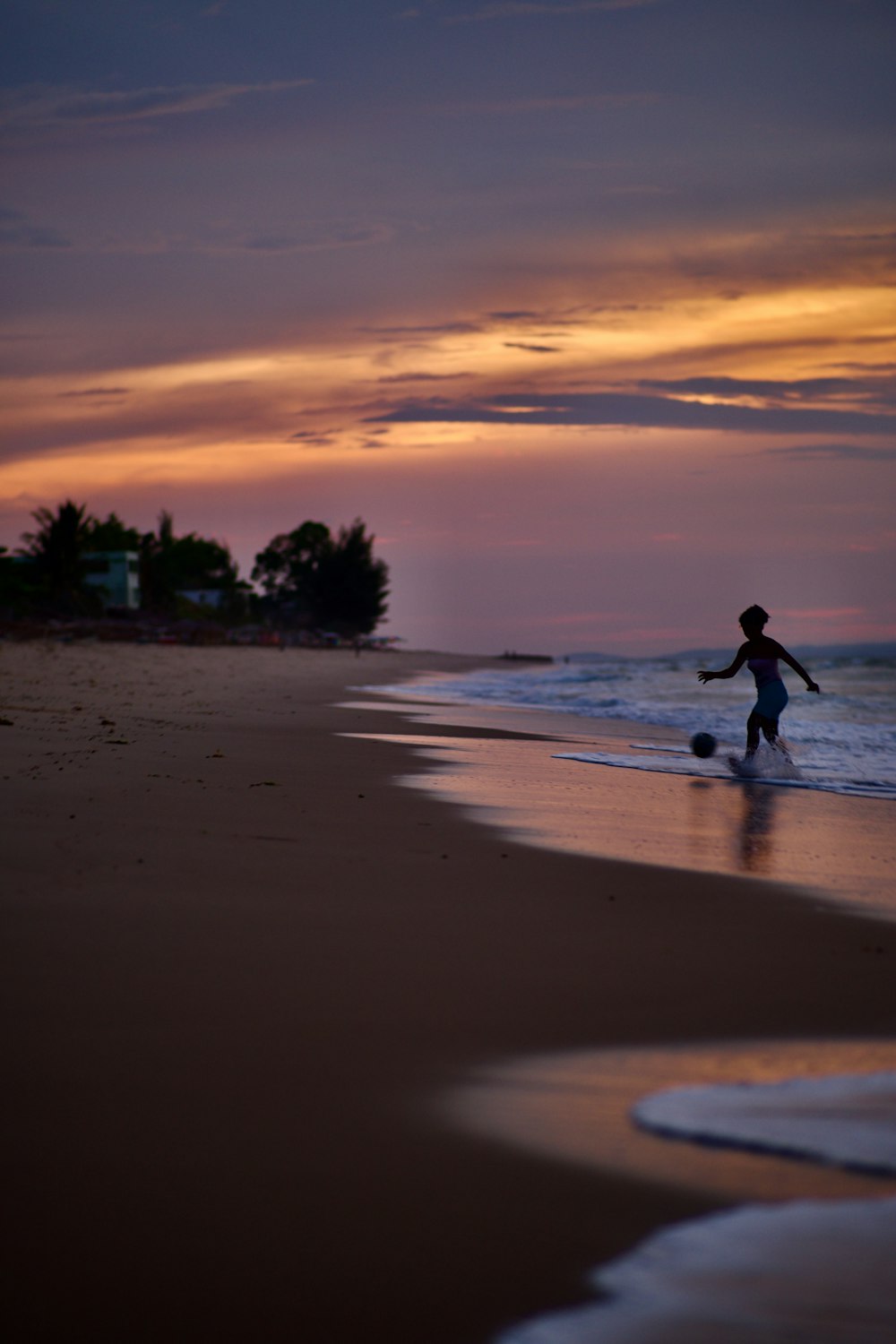 a person running on a beach at sunset