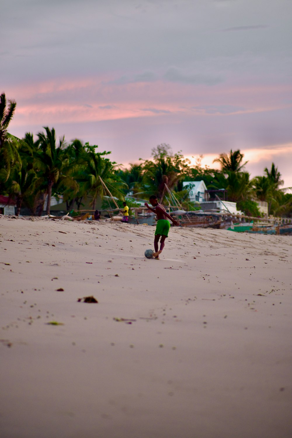 a person on a beach playing with a frisbee