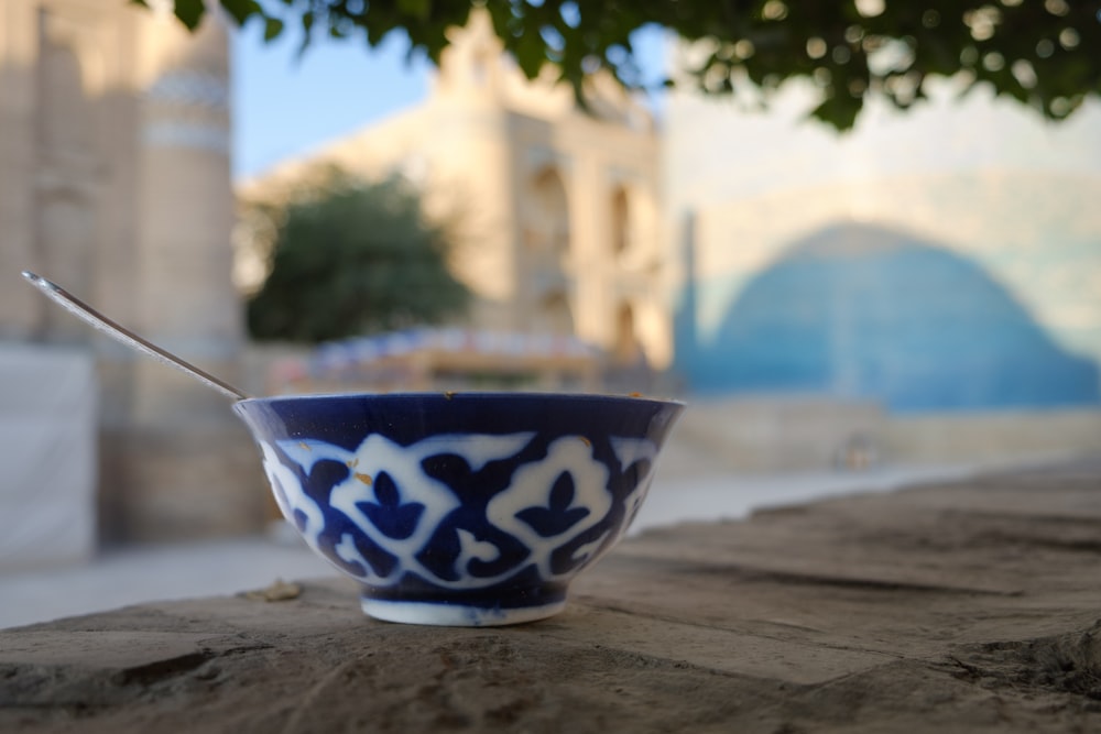 a blue and white bowl with a spoon in it