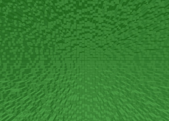 A geometric pattern composed of numerous small green cubes extending in a three-dimensional space. The cubes are tightly packed and vary slightly in shade, creating a sense of depth and complexity.