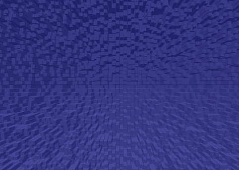 A digital artwork featuring a pattern of small, uniformly-shaped cubes arranged in a gradient, creating a sense of depth and perspective. The cubes are uniformly colored in shades of blue.