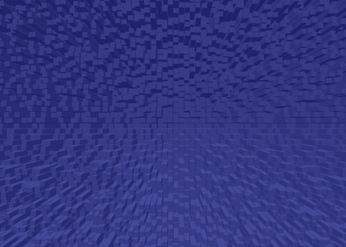 A digital artwork featuring a pattern of small, uniformly-shaped cubes arranged in a gradient, creating a sense of depth and perspective. The cubes are uniformly colored in shades of blue.
