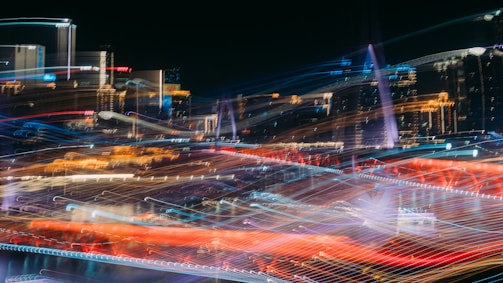 An urban night shot featuring dynamic light trails and layered visual effects.