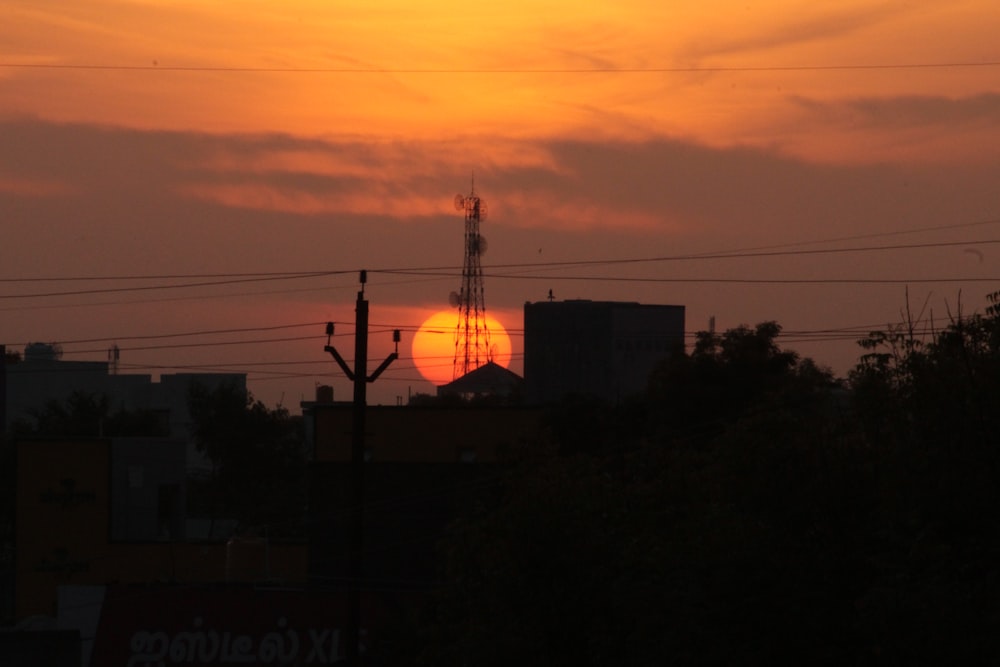 the sun is setting over a city skyline